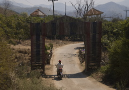 Meghan entering the gates of a village