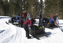 loading up the snowmobiles